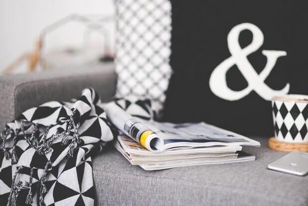 first home buyer research magazines on a sofa